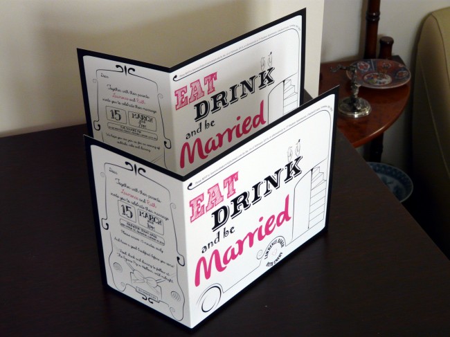 Retro and clean wedding invitations with pink and black writing saying 'eat drink and be married'