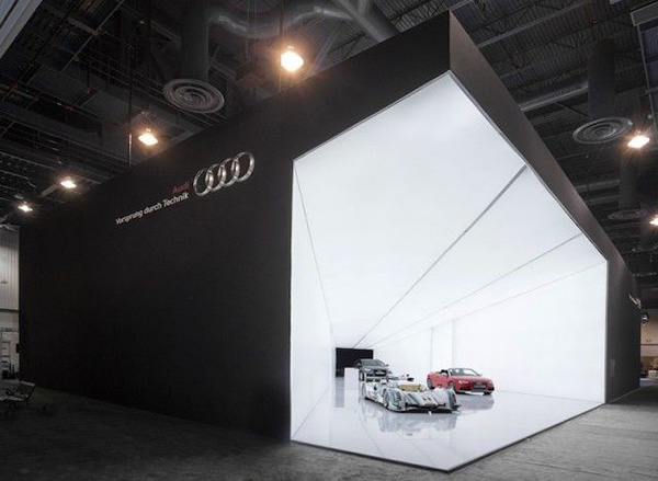 Striking exhibition stand by Audi shows a cone of light with Audi's premium cars 