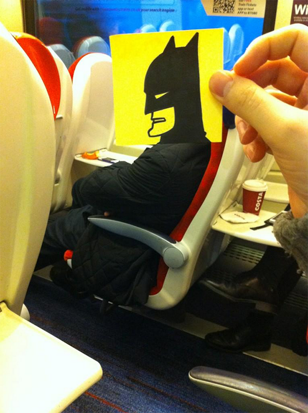 Funny, serious-looking photo of Batman's head put on top of an average commuter's