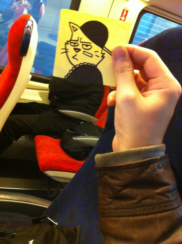 Funny sketch of a gangster cat put on top of a miserable-appearing commuter with their arms folded