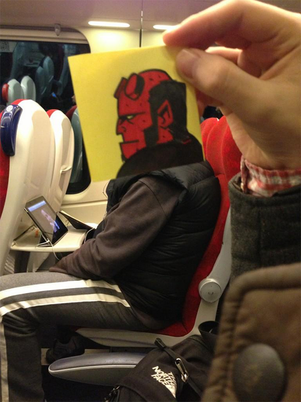 Clever sketch of Hell Boy's face position to look like its the head a of a real person watching a programme on their iPad on the train.