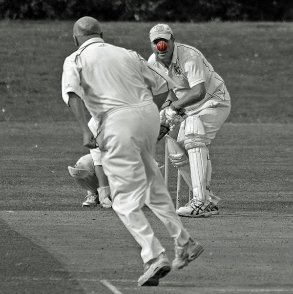Humorous photograph of British cricket players just as the red ball is perfectly at the batter's nose