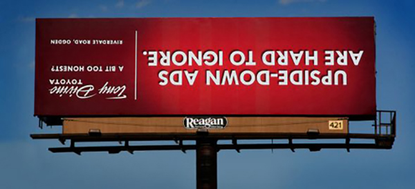 6 clever business signs - red upside down business sign on side of road.
