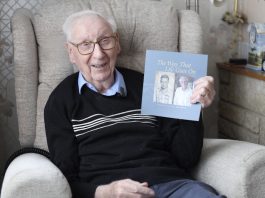 Eddie Habberley with his book of poetry